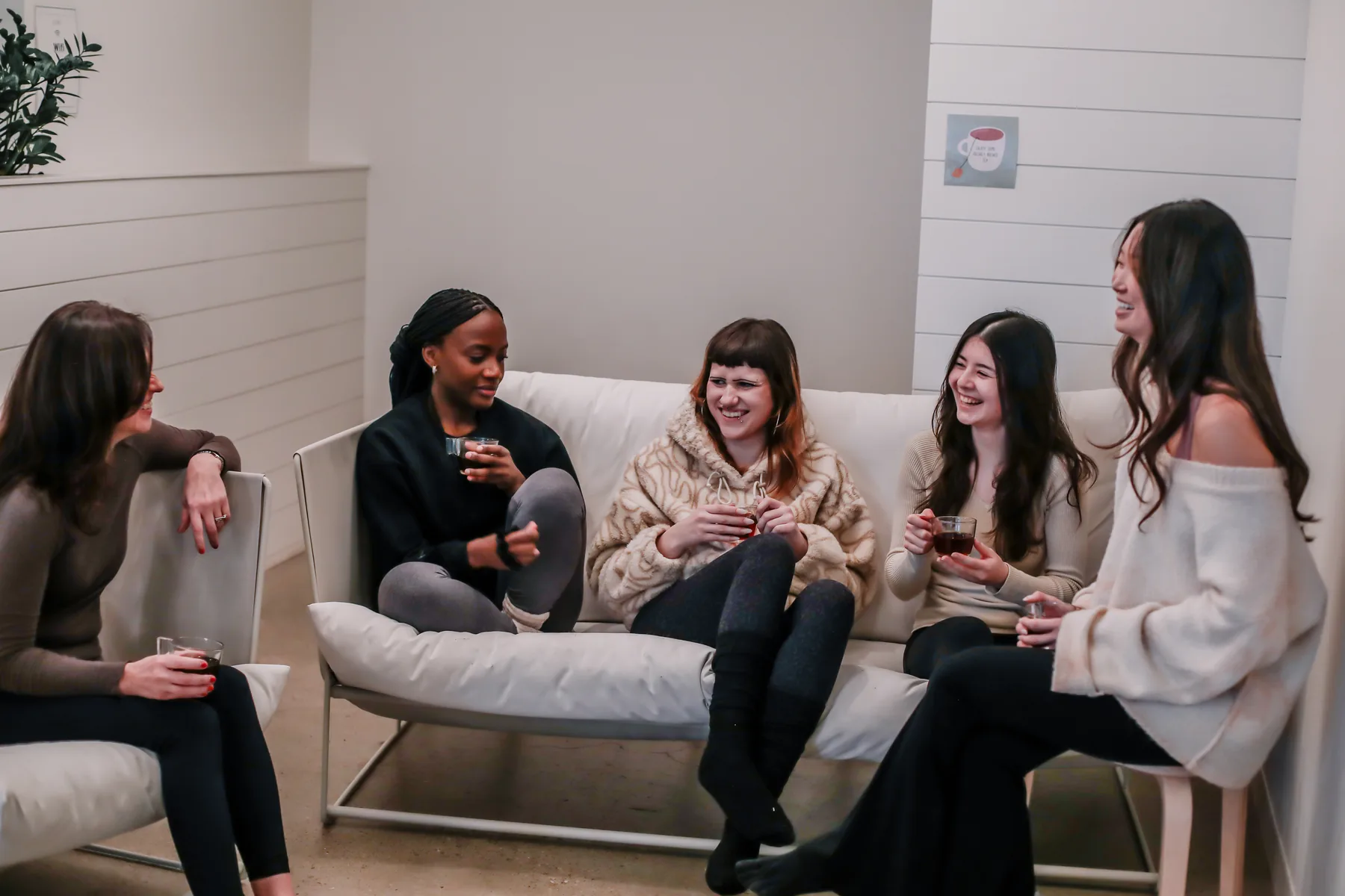 Yogalife members relaxing and chatting in the studio lounge.