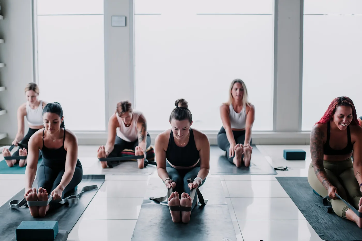 Yogalife members sitting together on their mats after class.