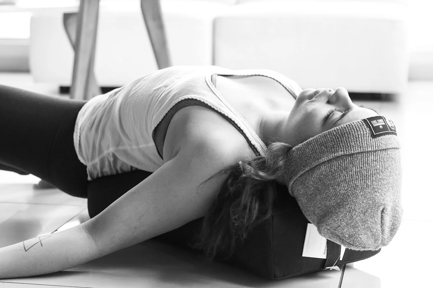 A Yogalife student resting comfortably in a supported pose.