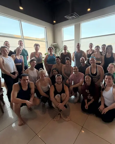 The whole group gathered for a photo by the studio windows after finishing all 108.
