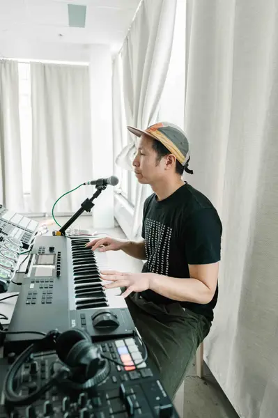 Marcus Fung playing a live ambient soundscape on a keyboard during class.