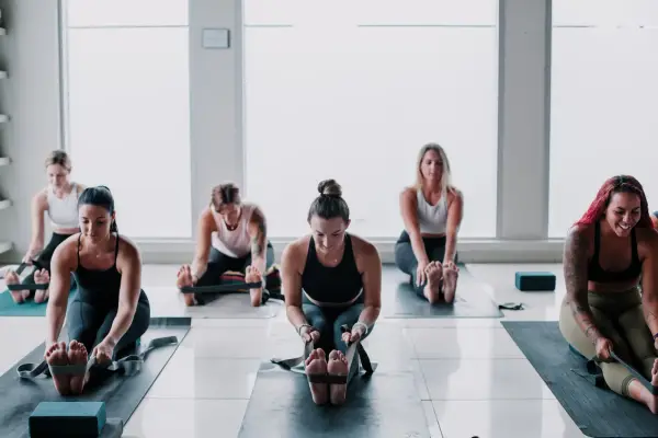 Students sitting together on their mats in the studio.