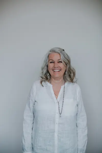 A longtime member standing for a portrait, smiling.